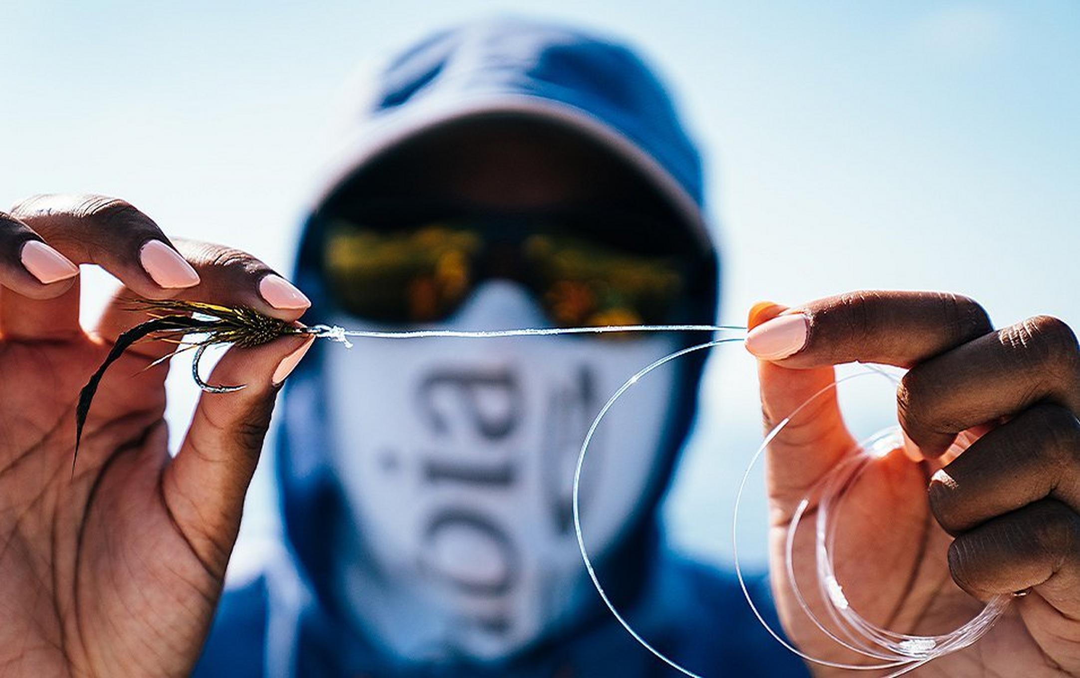 Person getting ready to fly fish.