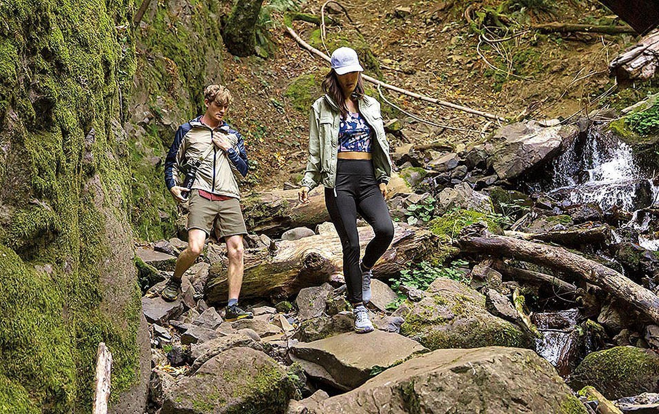 Man and woman hiking down rocky terrain
