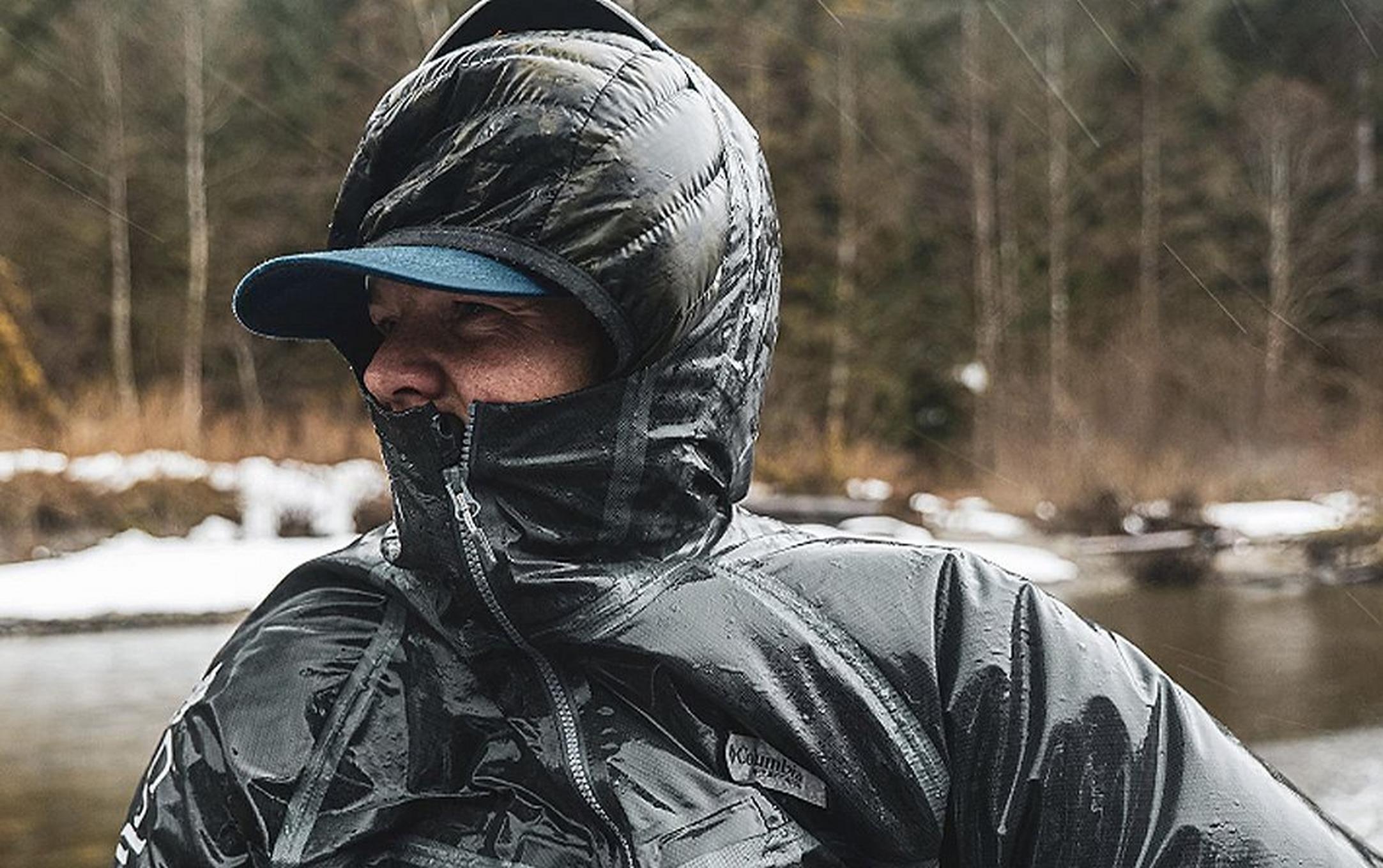 Pro angler Curtis Ciszek stands by a cold river in the wintertime wearing a Columbia Sportswear rain jacket.