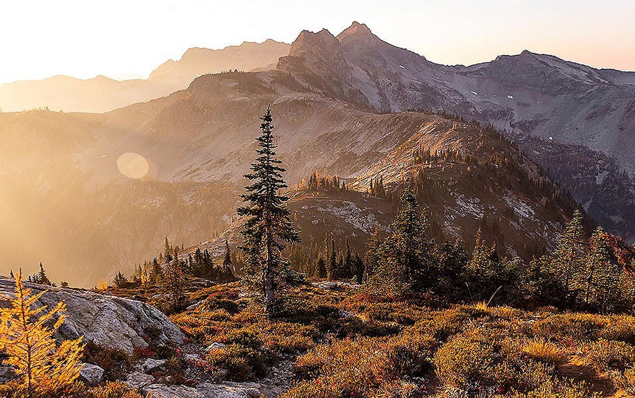 The sunset casts a beautiful orange light over the mountains at North Cascades National Park in Washington state.