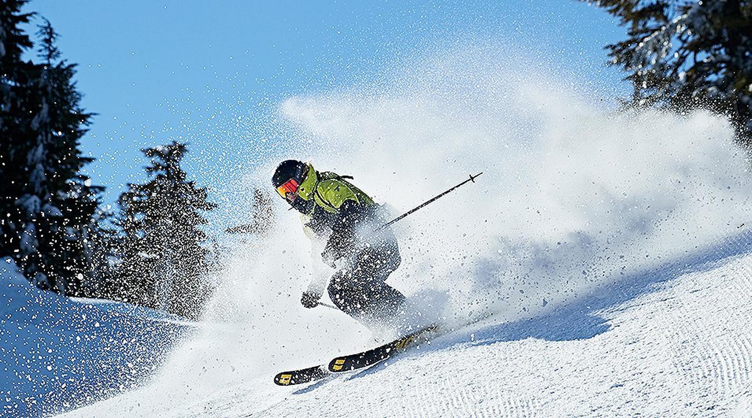 A skier carving on groomed snow.