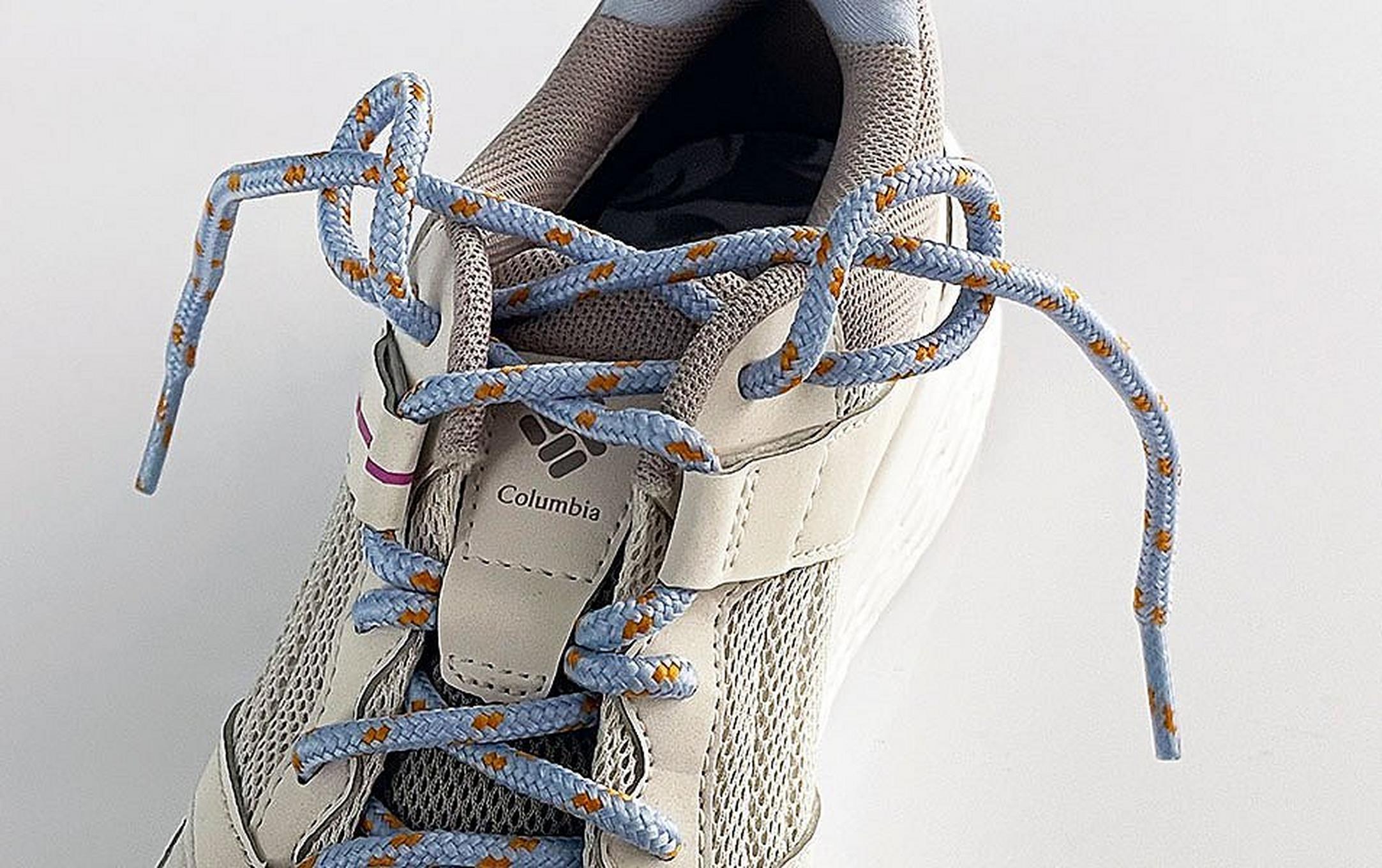 A close-up shot of a white Columbia Sportswear hiking shoe displaying a runner’s loop.
