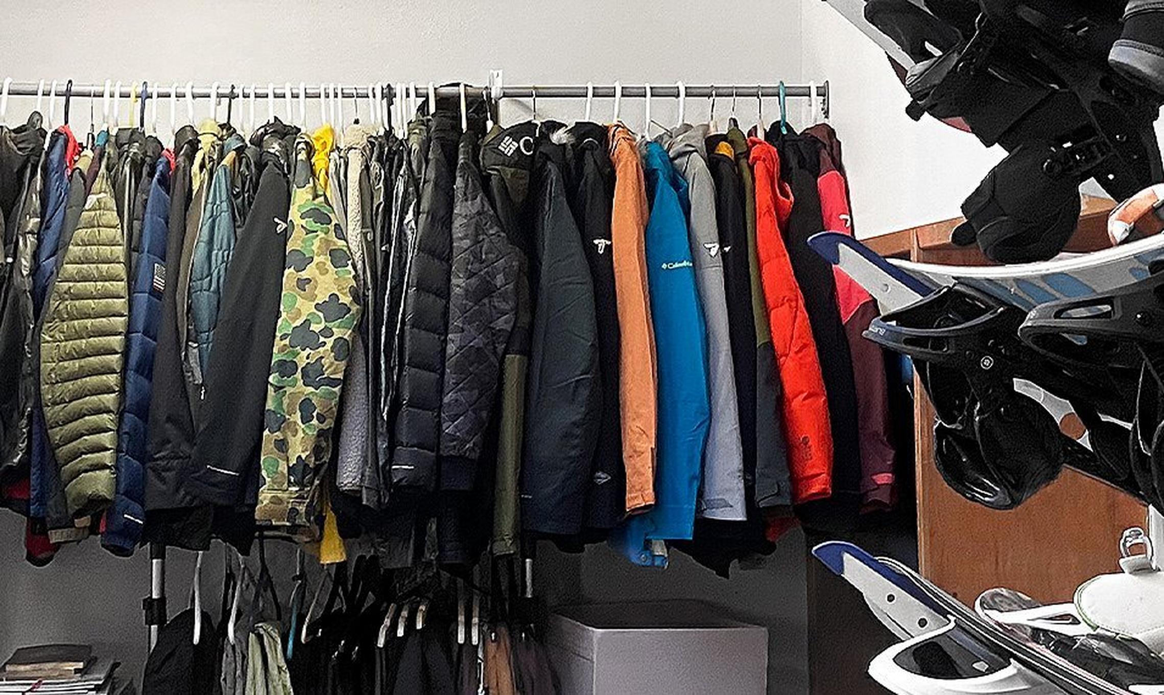 Rack of jackets and wall of snowshoes.