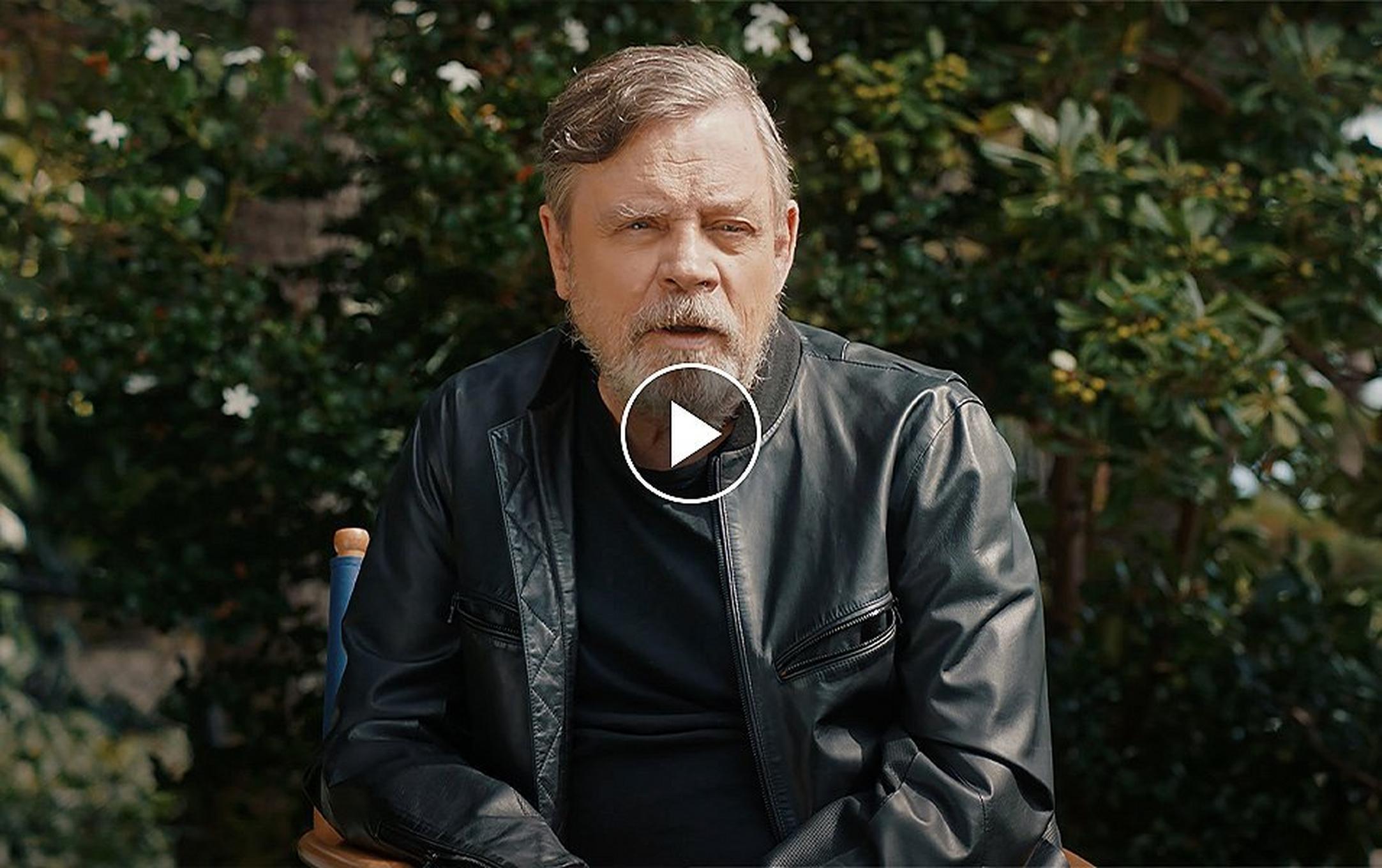 Video still of Mark Hamill discussing the collaboration between Star Wars and Columbia. Play button.
