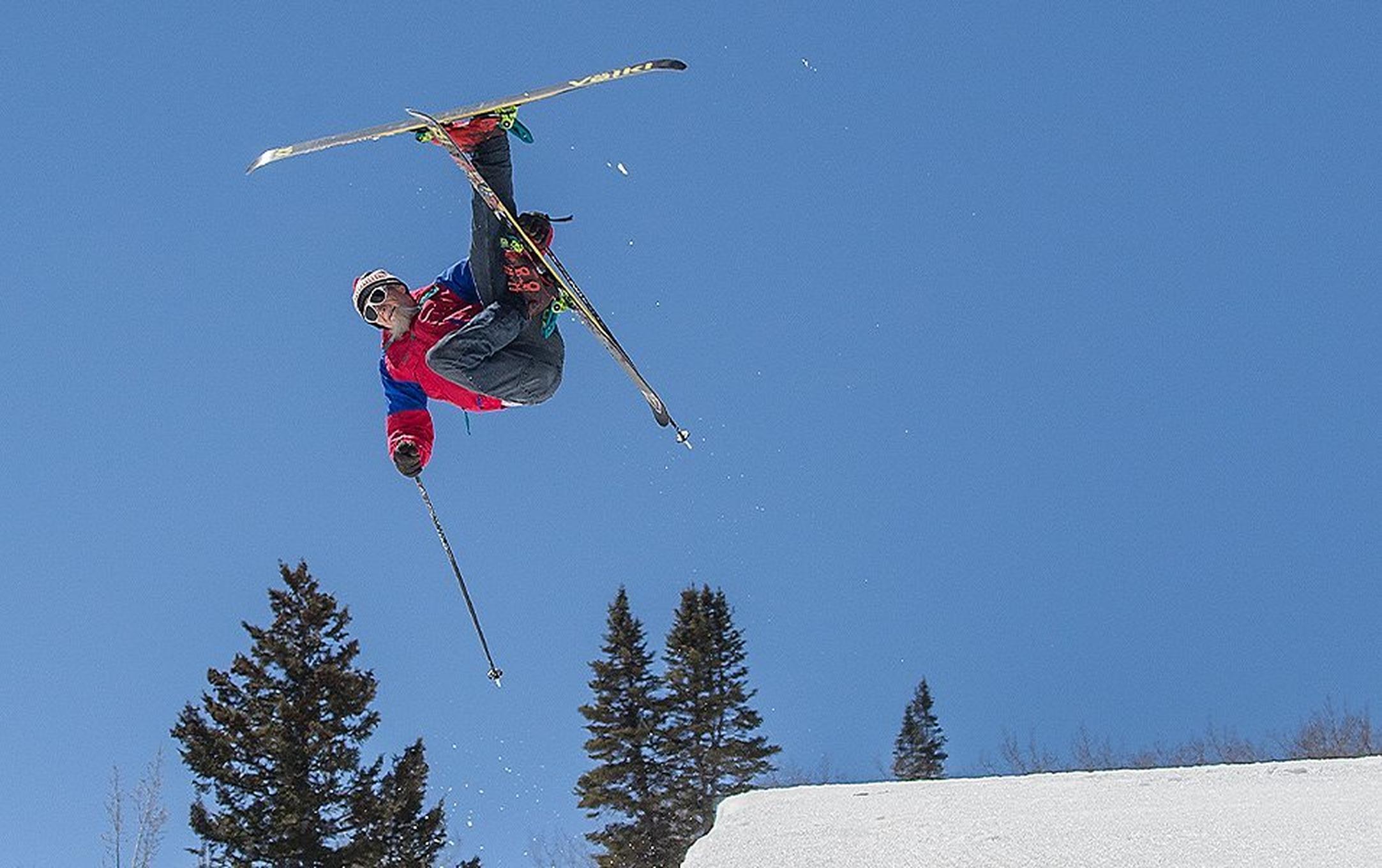 Hotdog Hans is pictured shooting out of the halfpipe in a red vintage ski jacket.