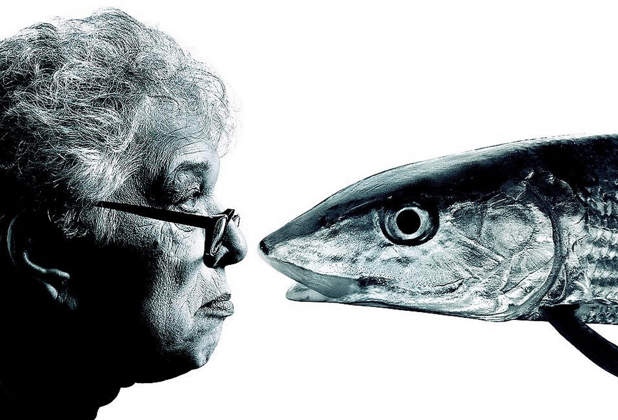 Gert Boyle profile face to face with a fish.