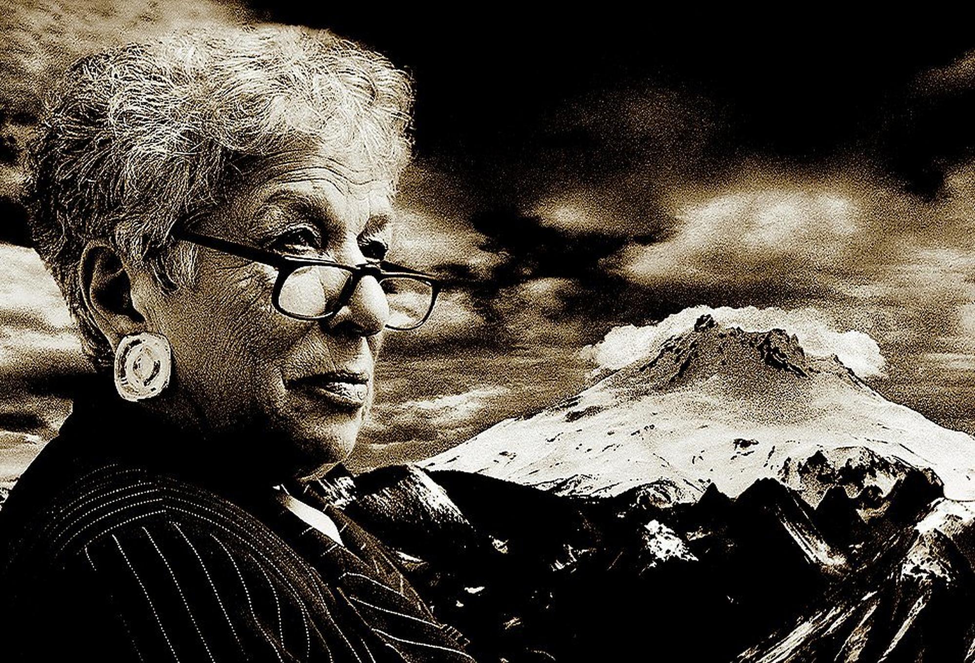 Close up of Gert Boyle overlaid on a snowy mountain background.