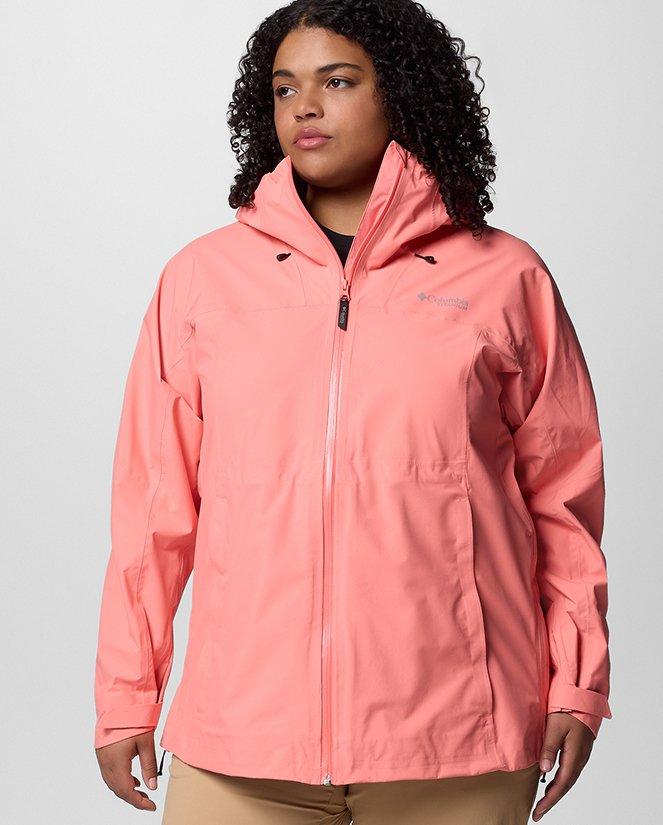 A woman wearing a coral rain jacket.