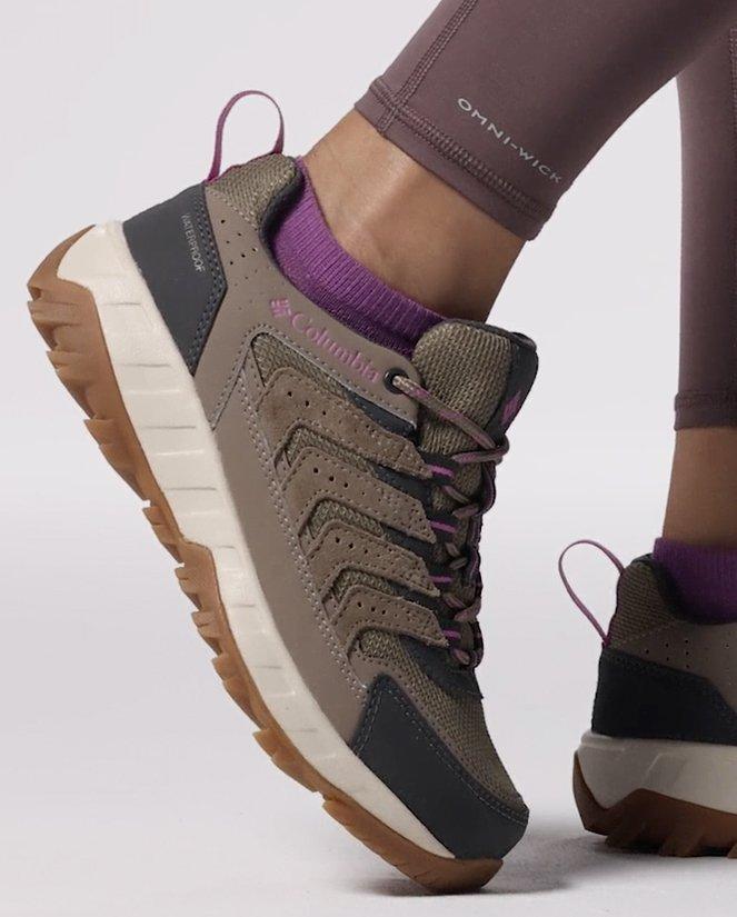Close-up of a woman's tan hiking shoes.