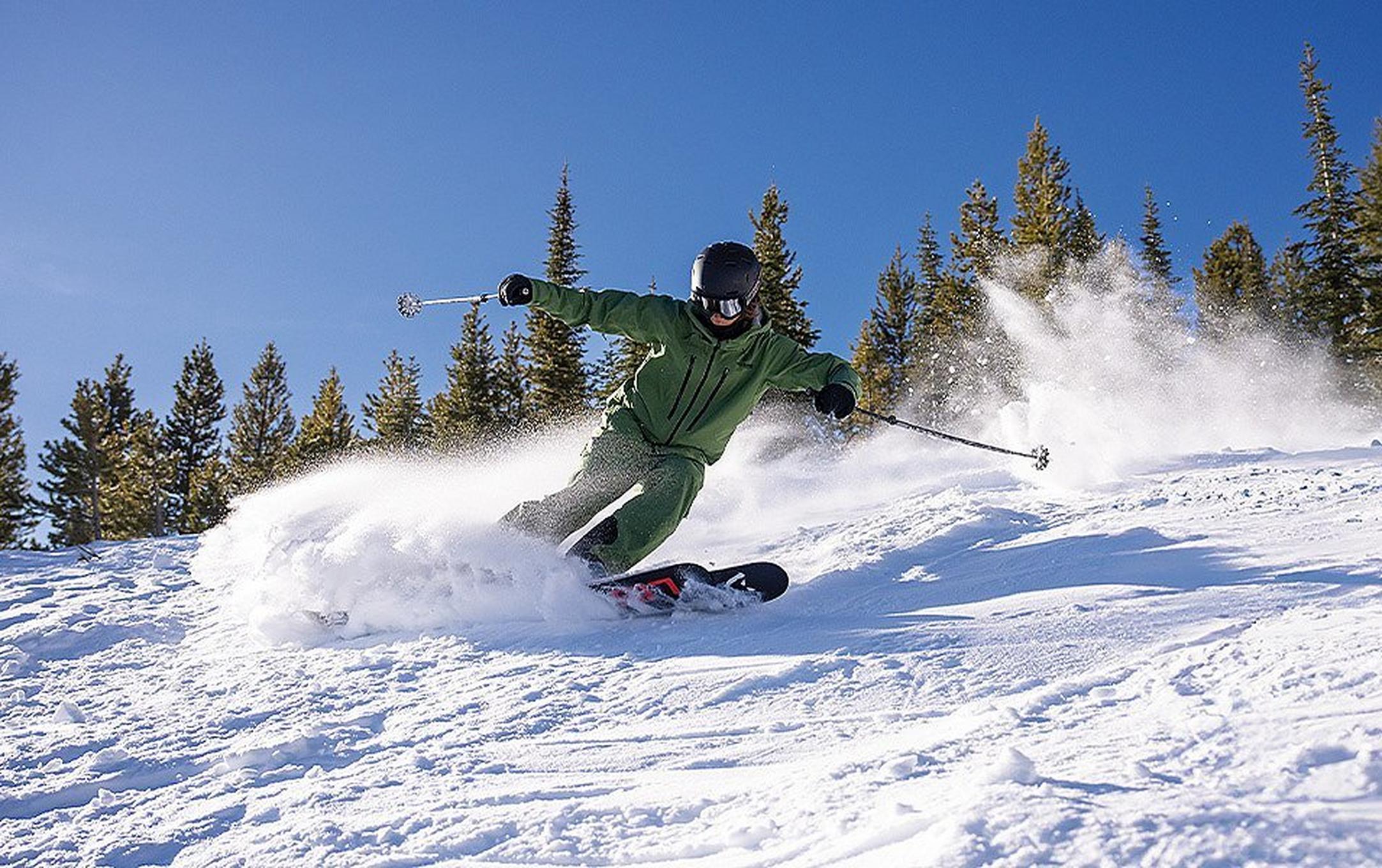 A young skier makes a smooth turn on a perfect bluebird day.