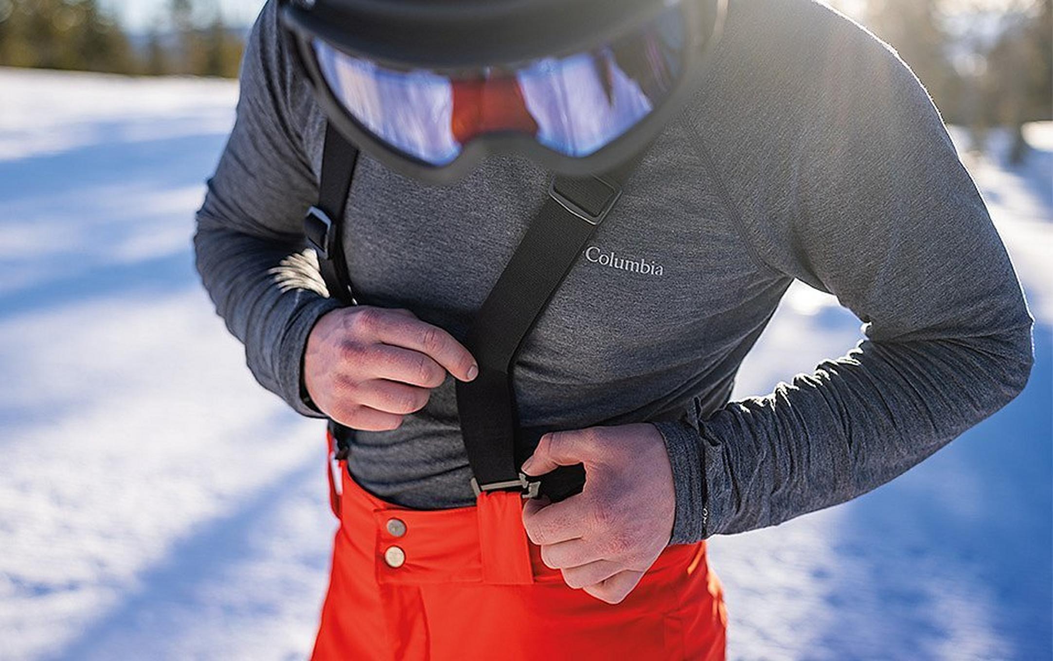This skier double-checks the suspenders on his bibs before heading down the slopes.