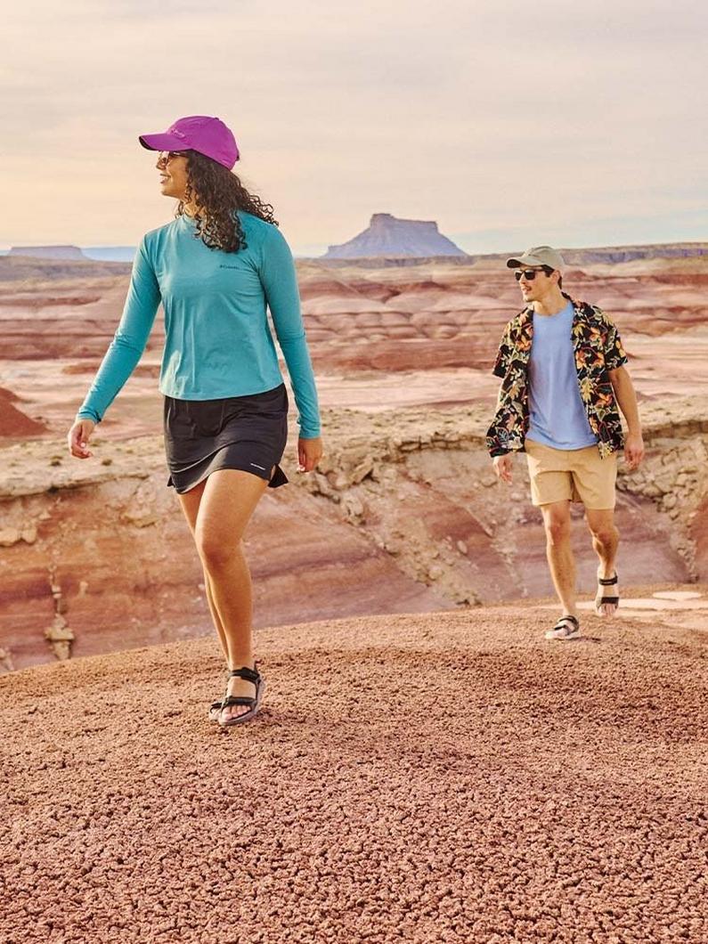 Man and women walking in the hot desert.