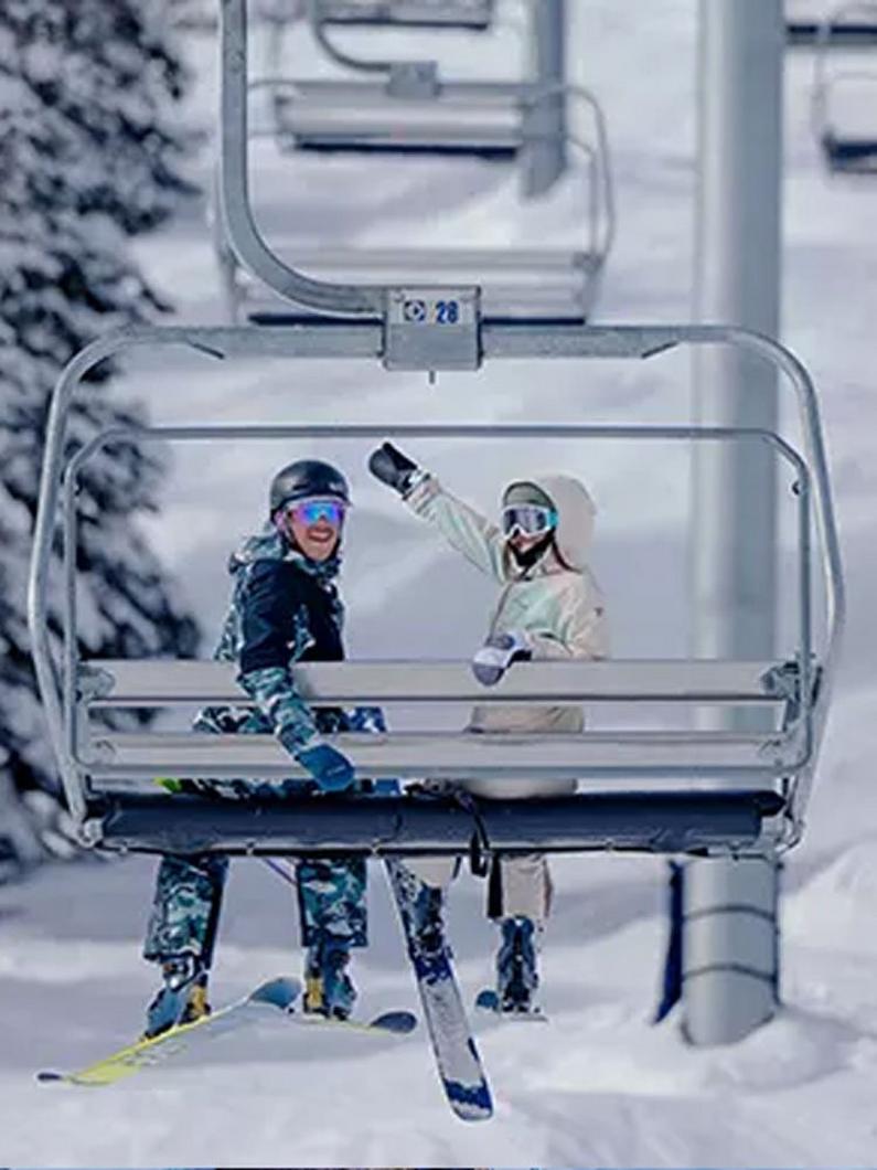 Two people on a ski lift.