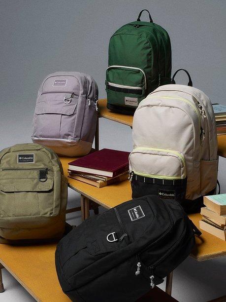 Stack of backpacks on wooden steps