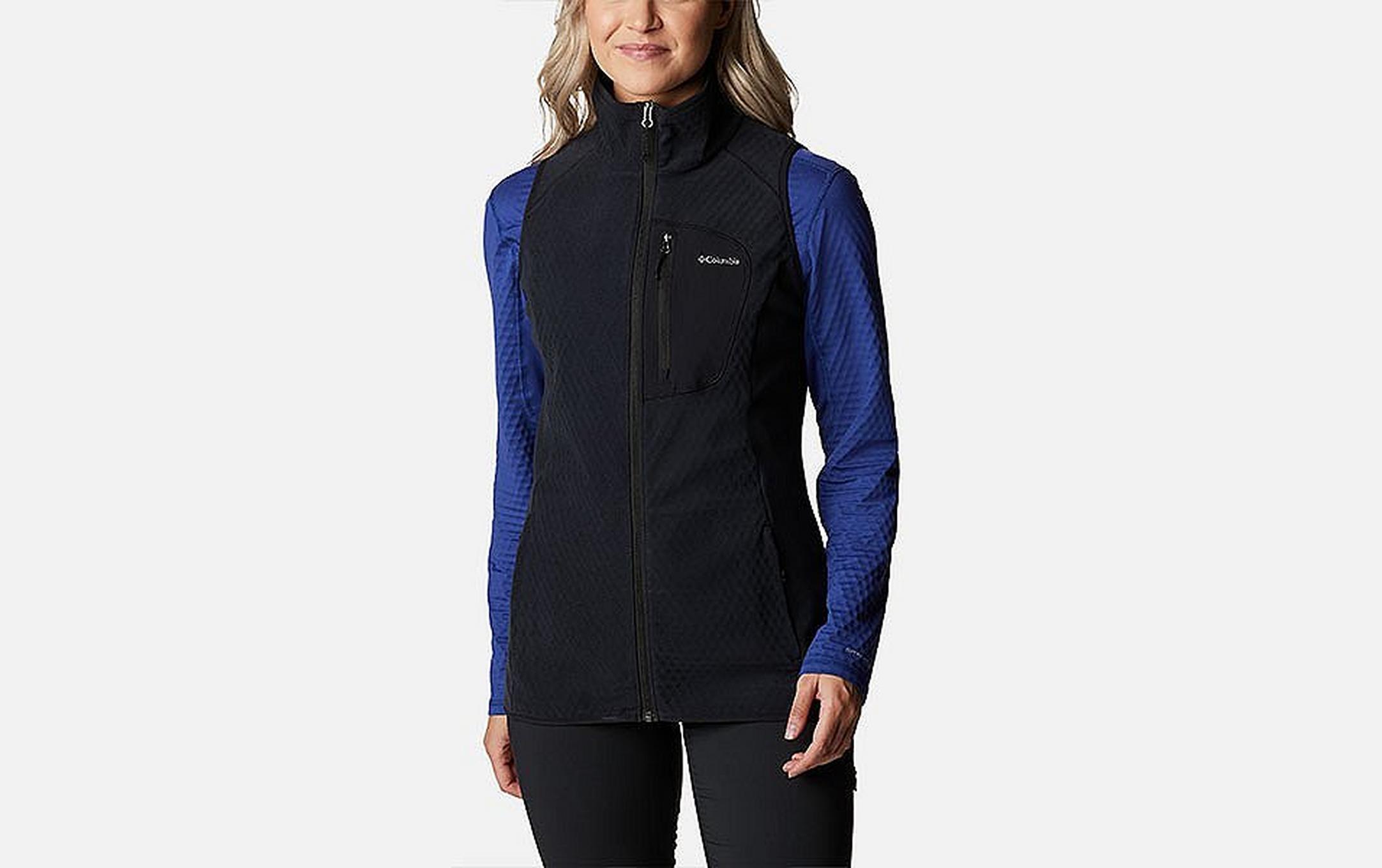 A product image of a woman wearing Columbia Sportswear’s Outdoor Tracks Vest against a white background.