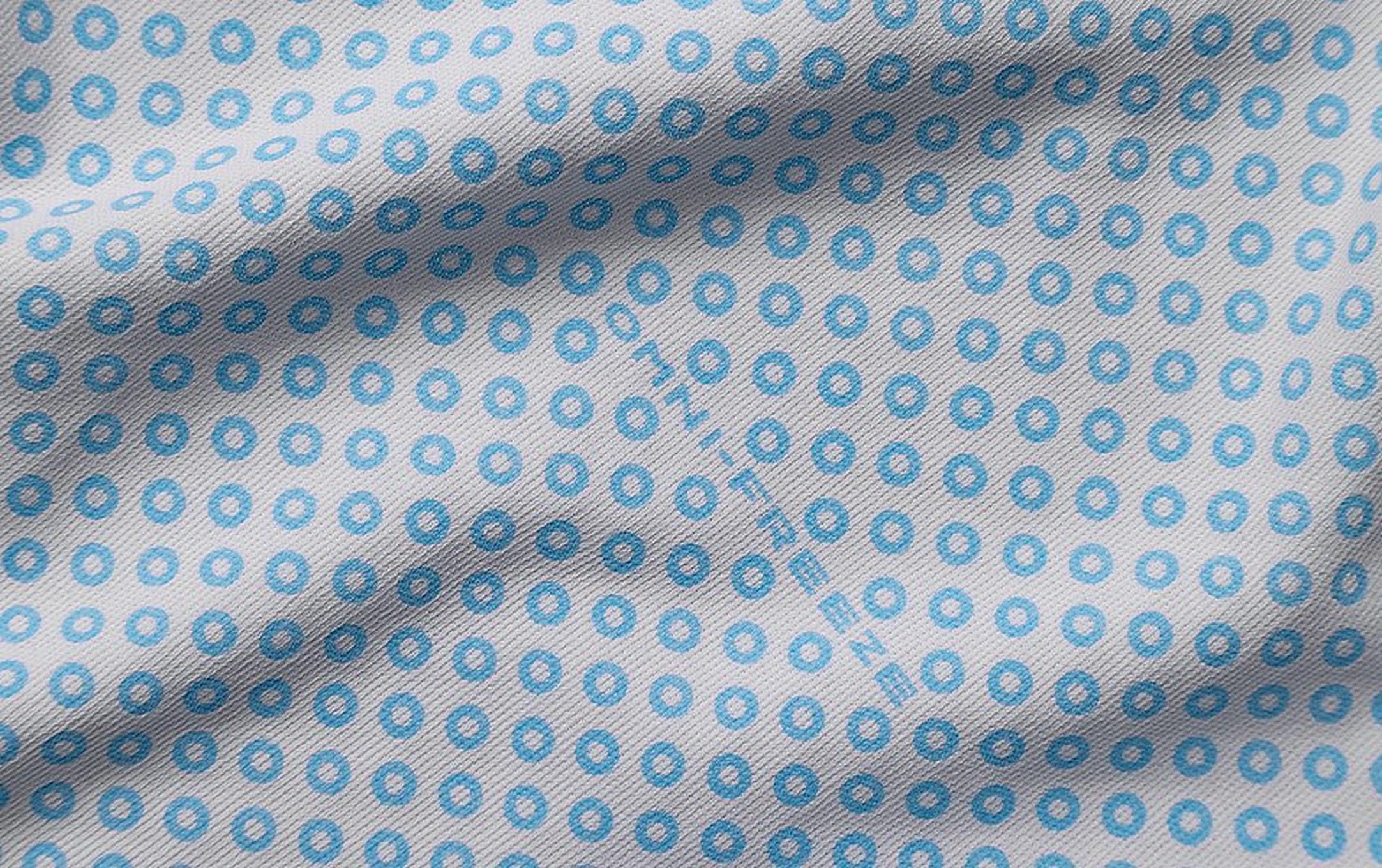 A close-up of Columbia’s Omni-Freeze Zero highlights its small blue circles, showcasing the visible cooling technology.