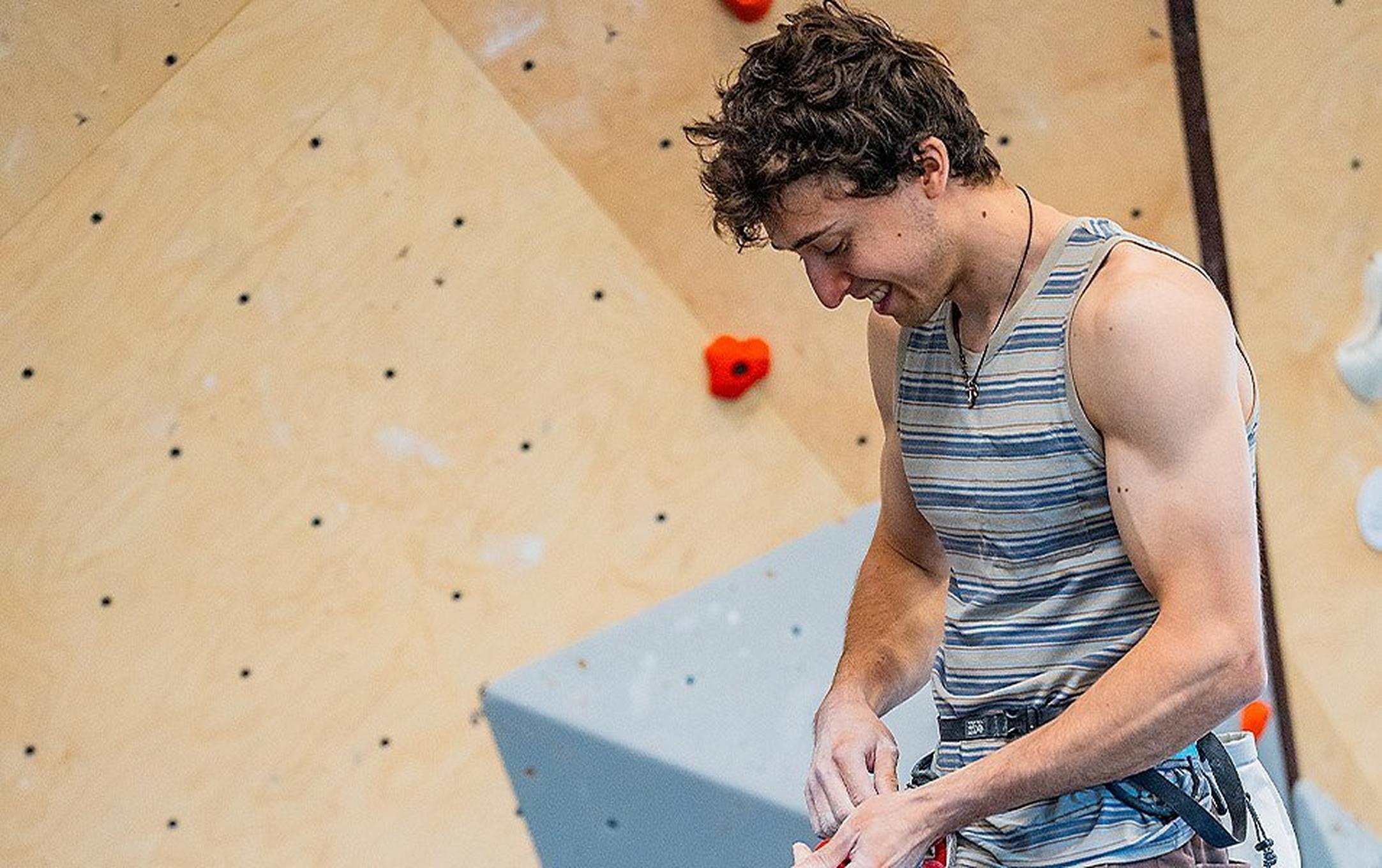 US Climbing Team member/Olympic athlete, Jesse Grupper, tying a figure eight knot before climbing in an indoor gym.