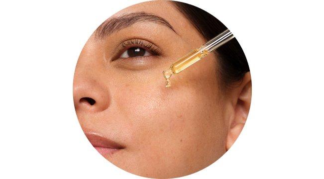 person applying product serum to face