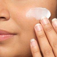 Person applying The Ordinary moisturizer to face