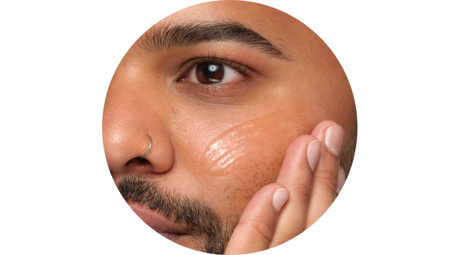 Person applying serum to face