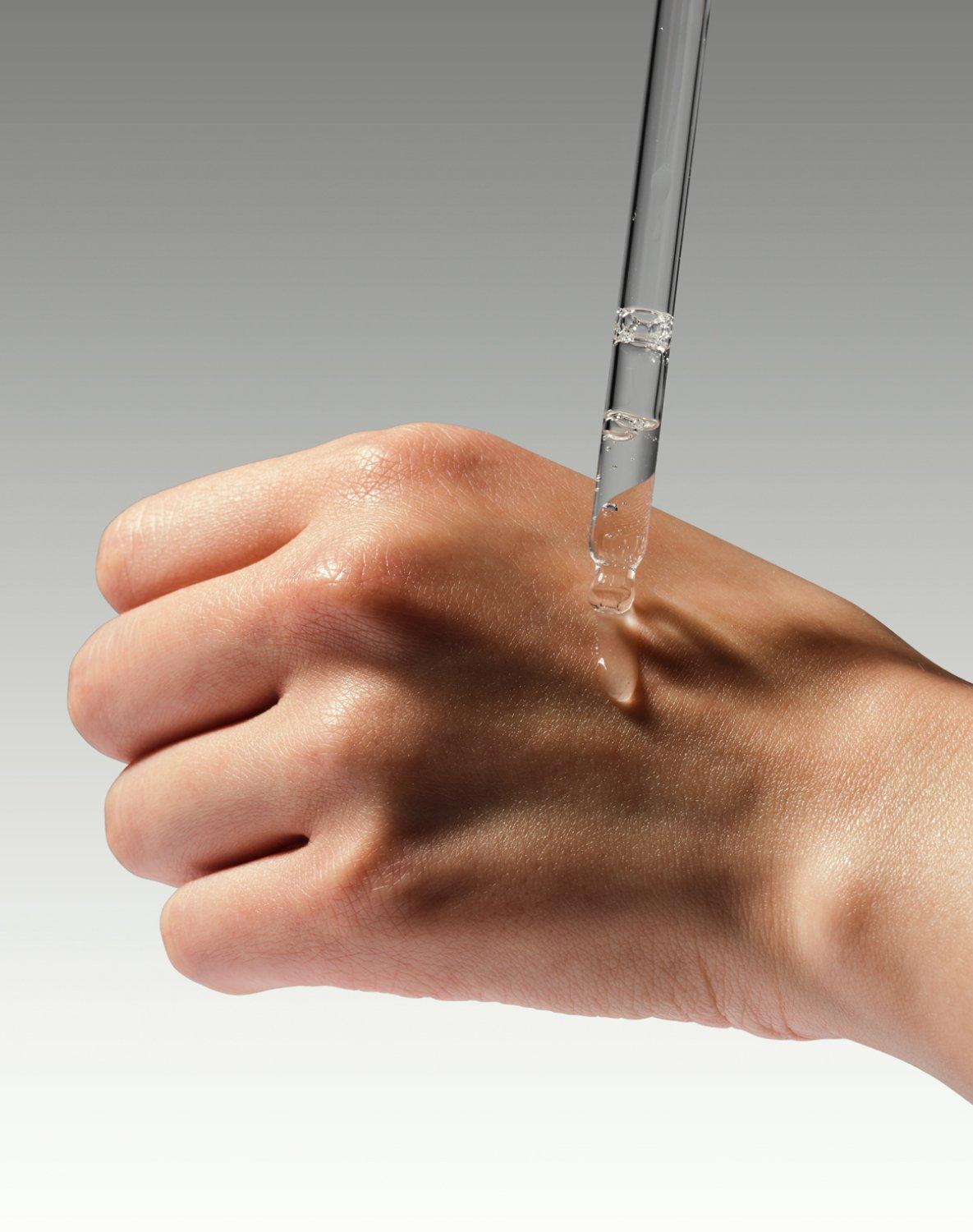 Person applying The Ordinary GF 15% to hand