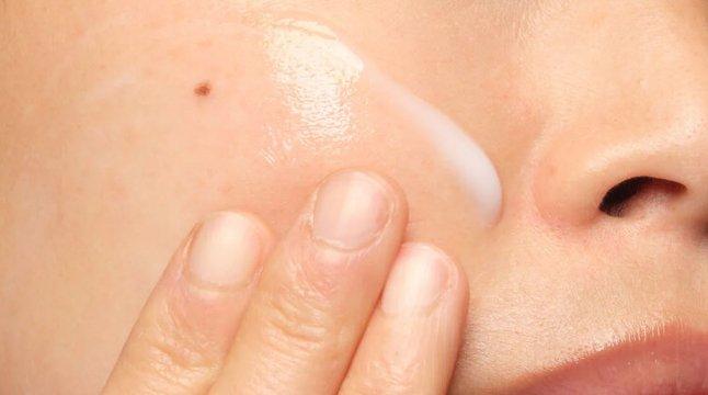 Person applying The Ordinary product to cheek