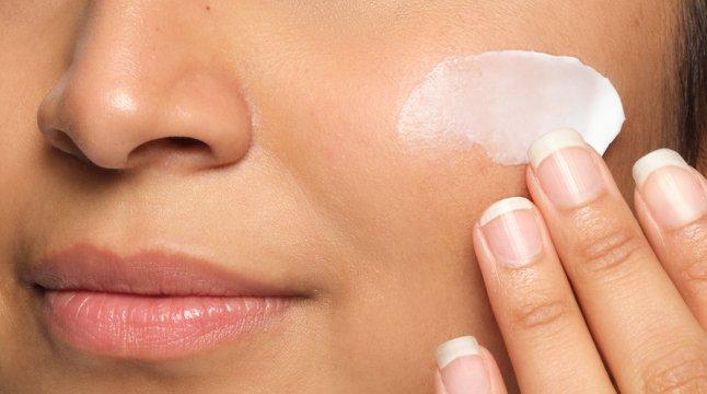 Person applying The Ordinary moisturizer to face