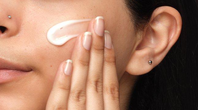 Person applying The Ordinary product to face