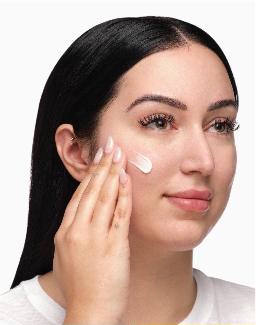 Person applying serum on face