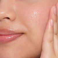 Person applying The Ordinary serum to skin