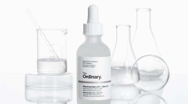 The Ordinary Niacinamide 10% + Zinc 1% on a table with lab beakers