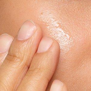 Person applying The Ordinary serum to skin