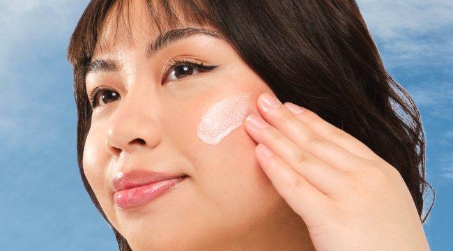 The Ordinary UV Filters SPF 45 Serum: Light-skinned woman applying broad-spectrum, no white cast sunscreen for daily UV protection.