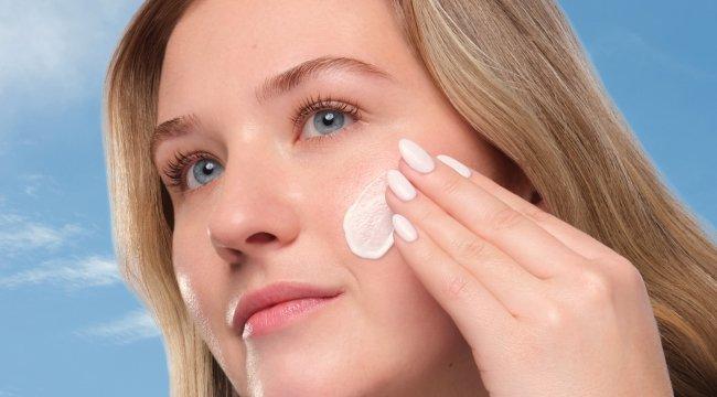 The Ordinary UV Filters SPF 45 Serum: Fair-skinned woman applying broad-spectrum, no white cast sunscreen for daily UV protection.