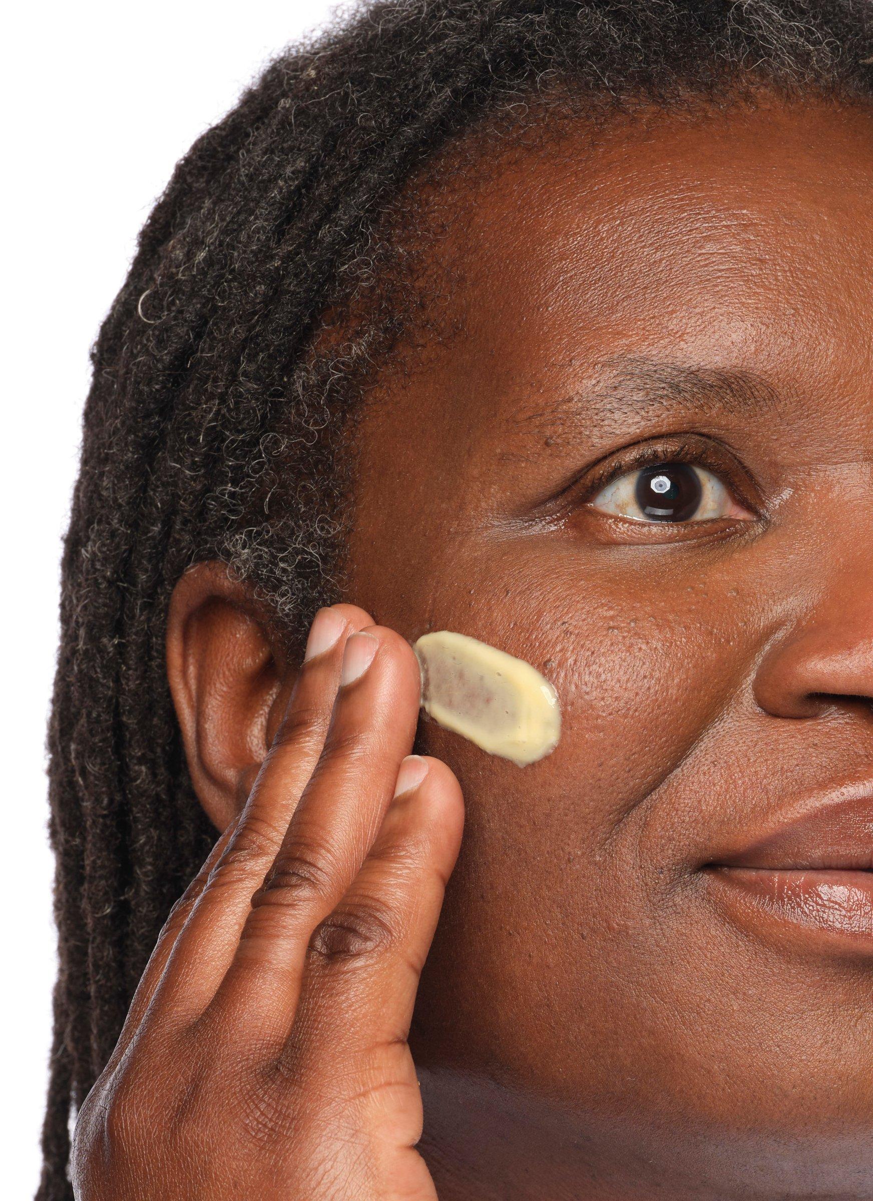 Person applying The Ordinary Retinal 0.2% Emulsion to face