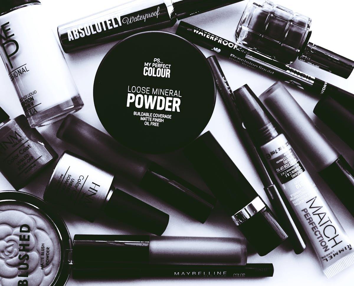 a bunch of makeup products are laid out on a table