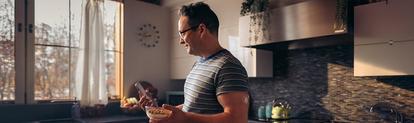 Man checking his Dexcom G7 application before eating breakfast