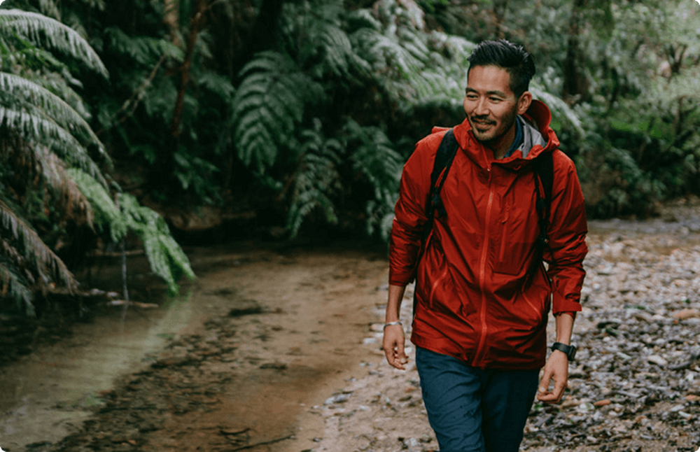 Man hiking next to a stream