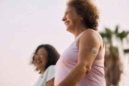 women walking and wearing the Dexcom CGM