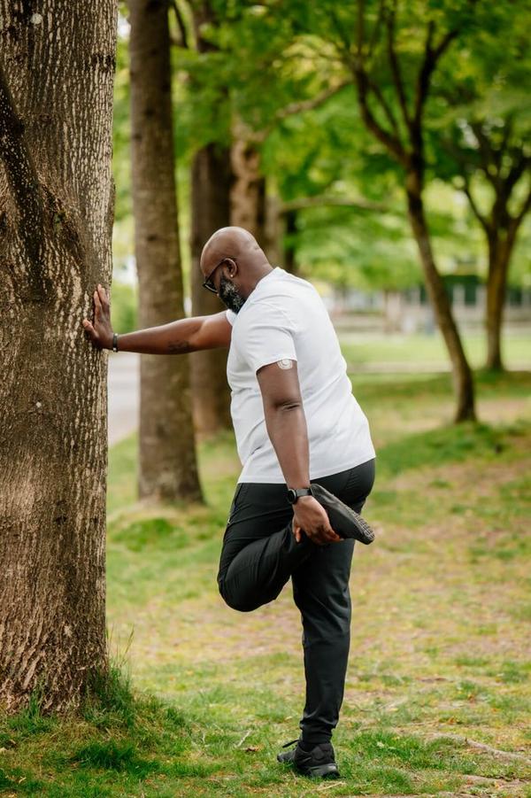 man stretching in the woods
