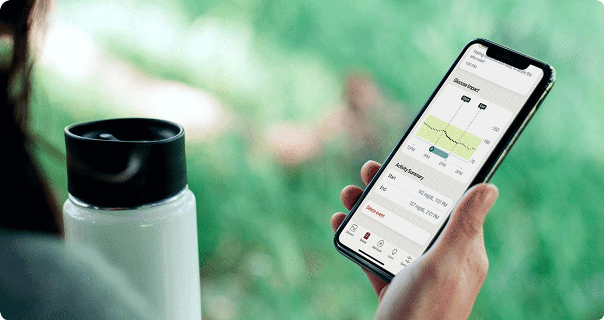 Woman checking her levels on her phone while outside