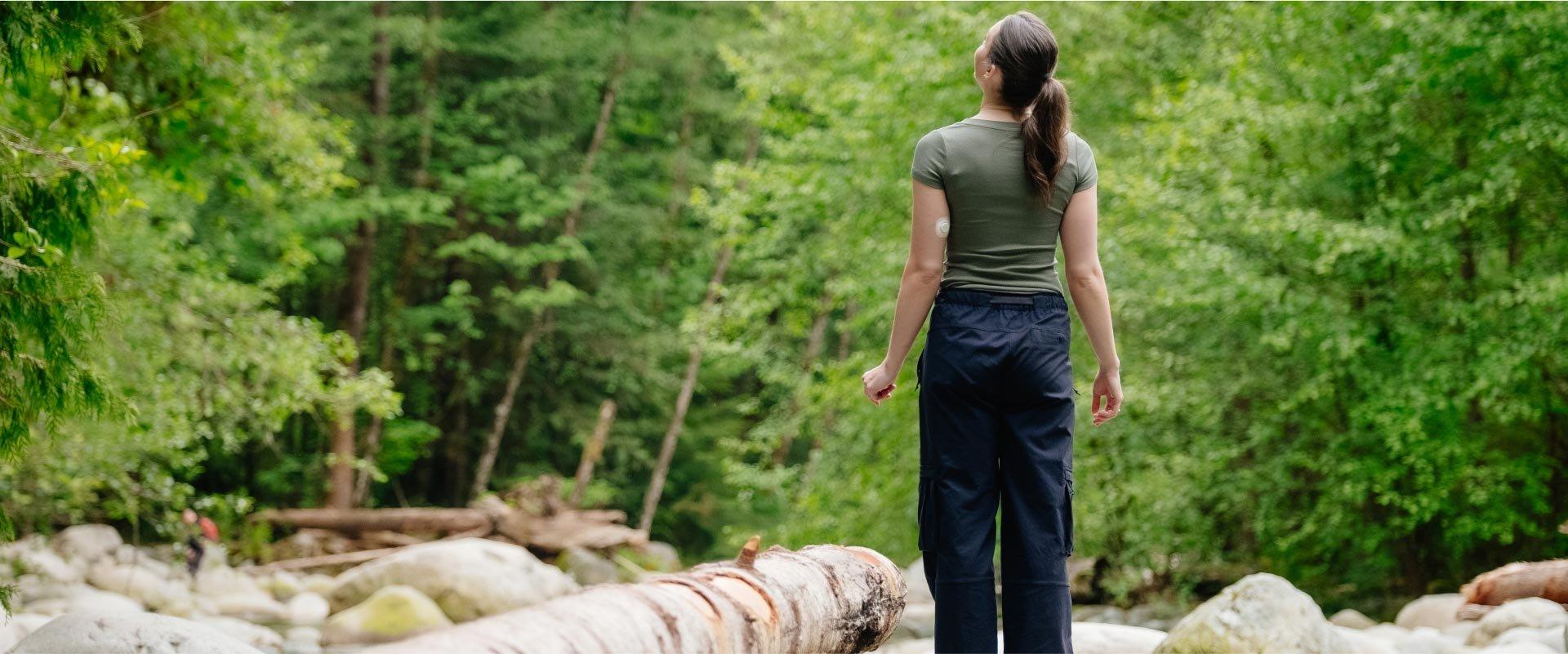 woman wearing Dexcom G7 CGM on back of arm and taking a walk
