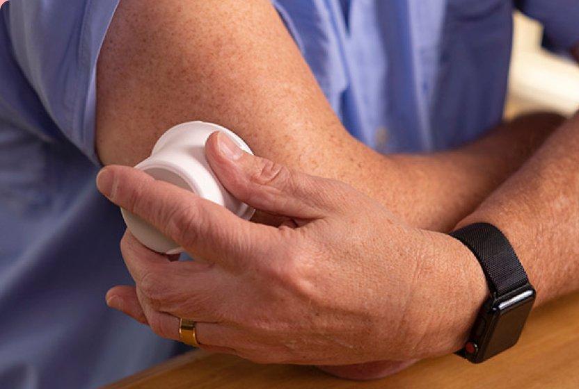 hand applying using applicator on upper arm