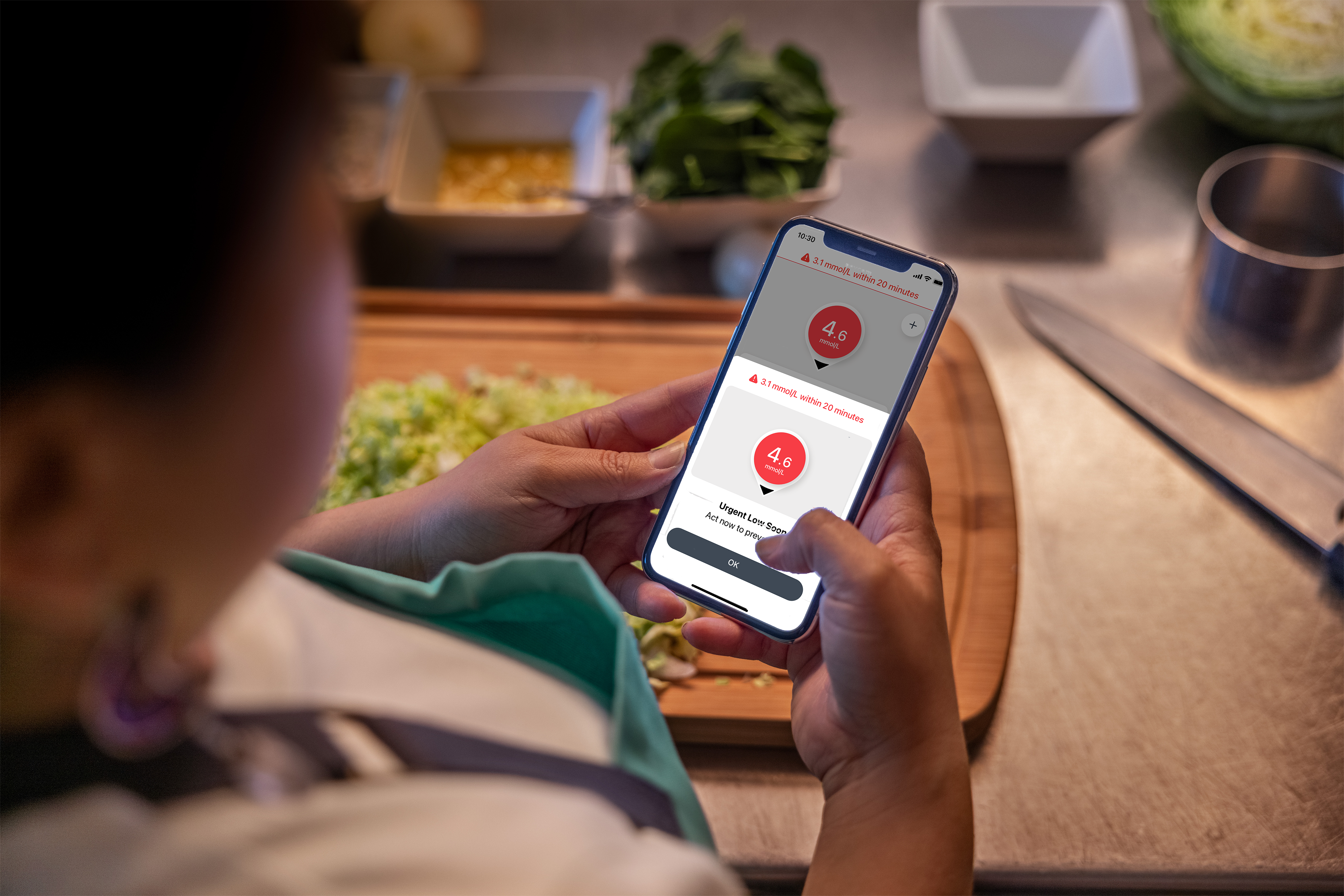 Smartphone showing G7 device information with vegetables cooking in the background