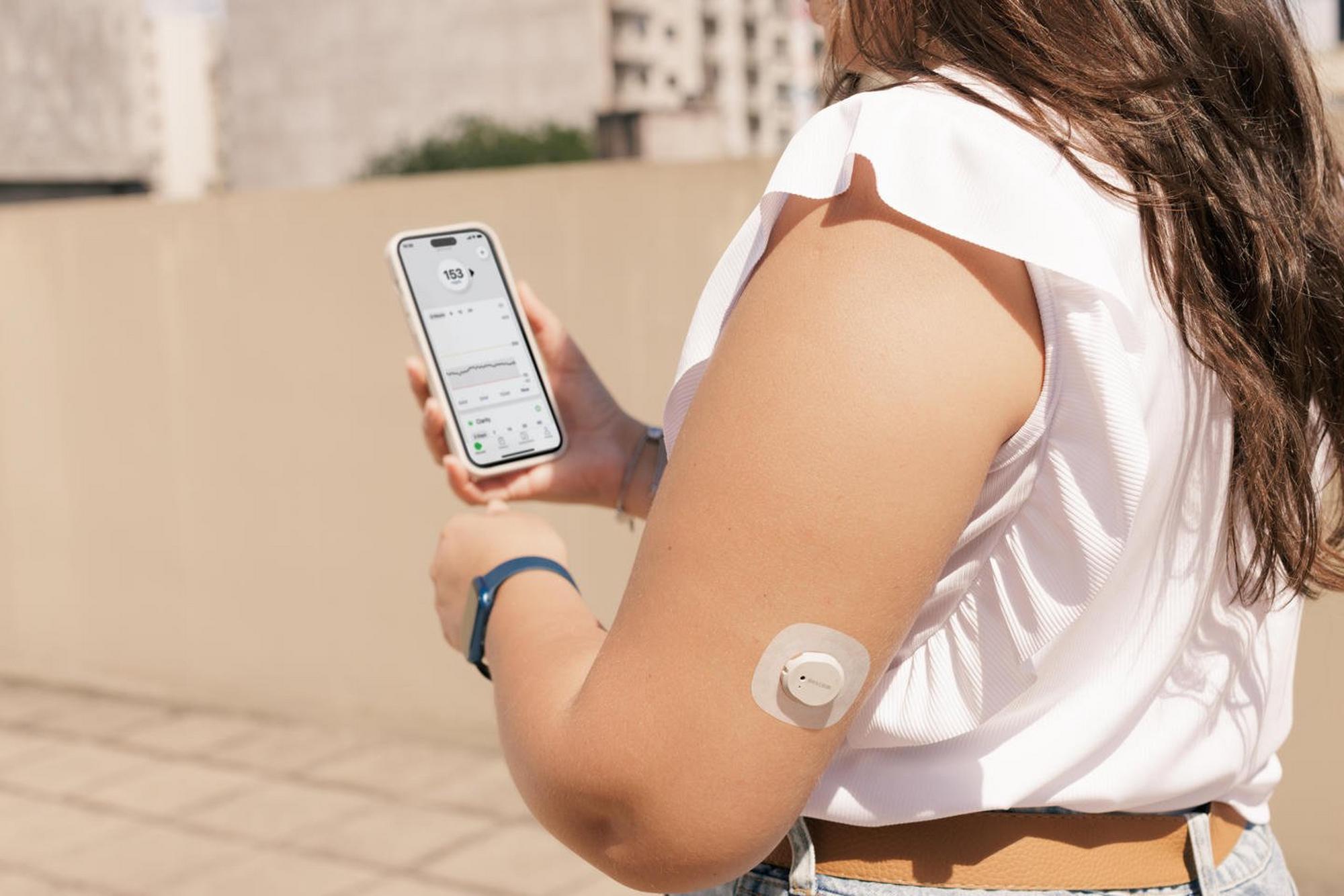 Girl looking at phone while walking and wearing sensor