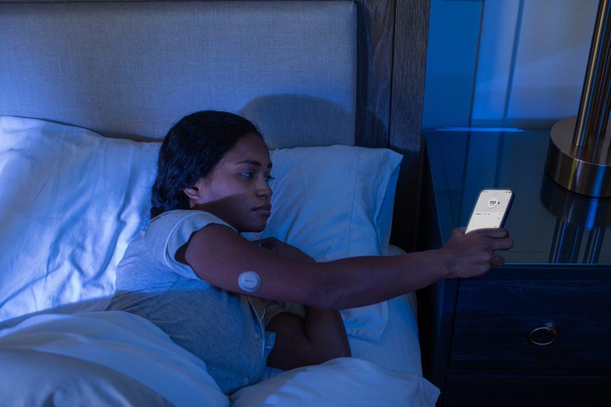 young woman with diabetes wearing a Dexcom CGM sensor