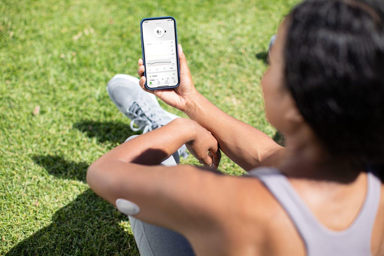 Teenager checking out CGM data on their mobile device