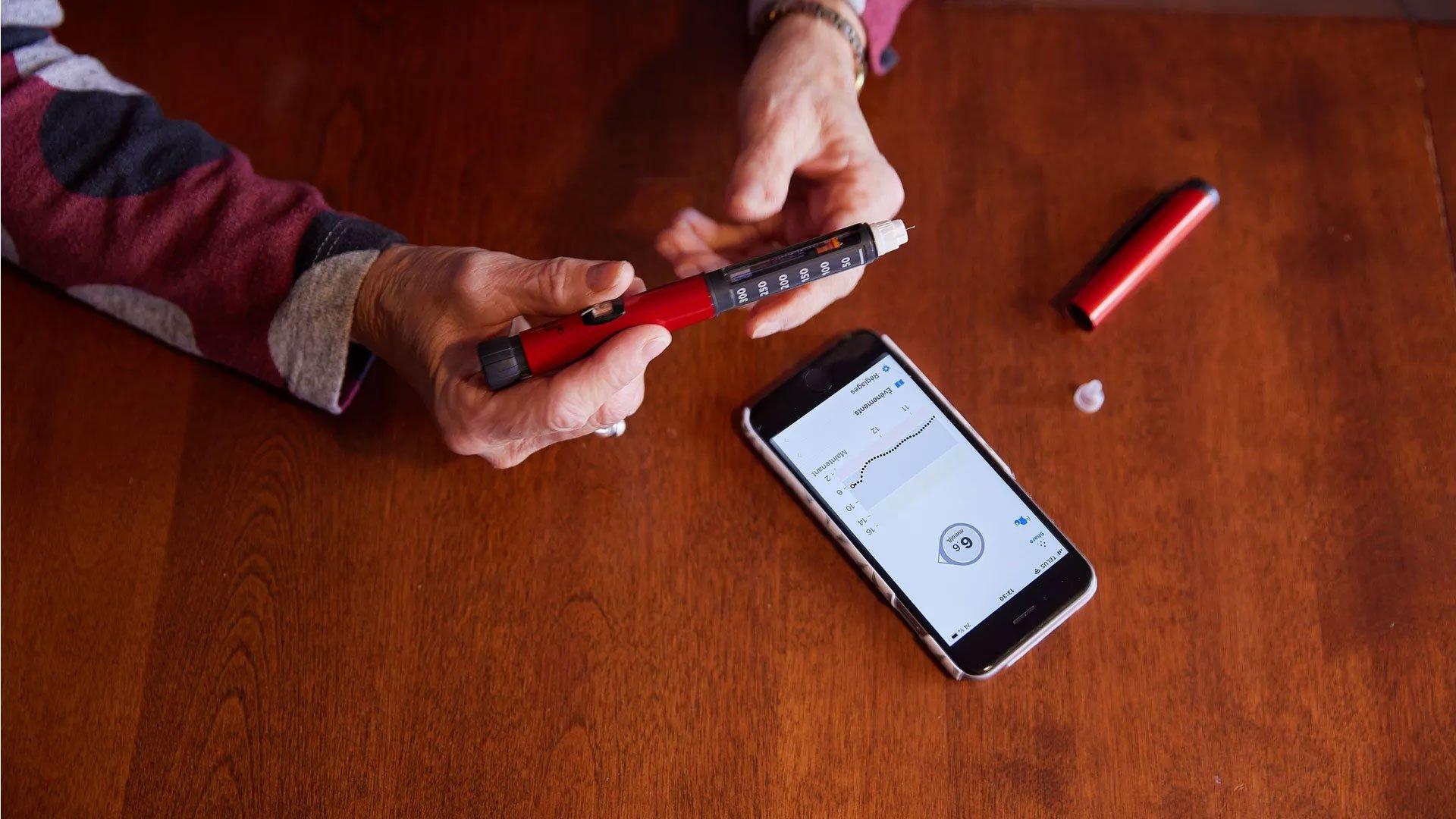 Man observing insulin pen
