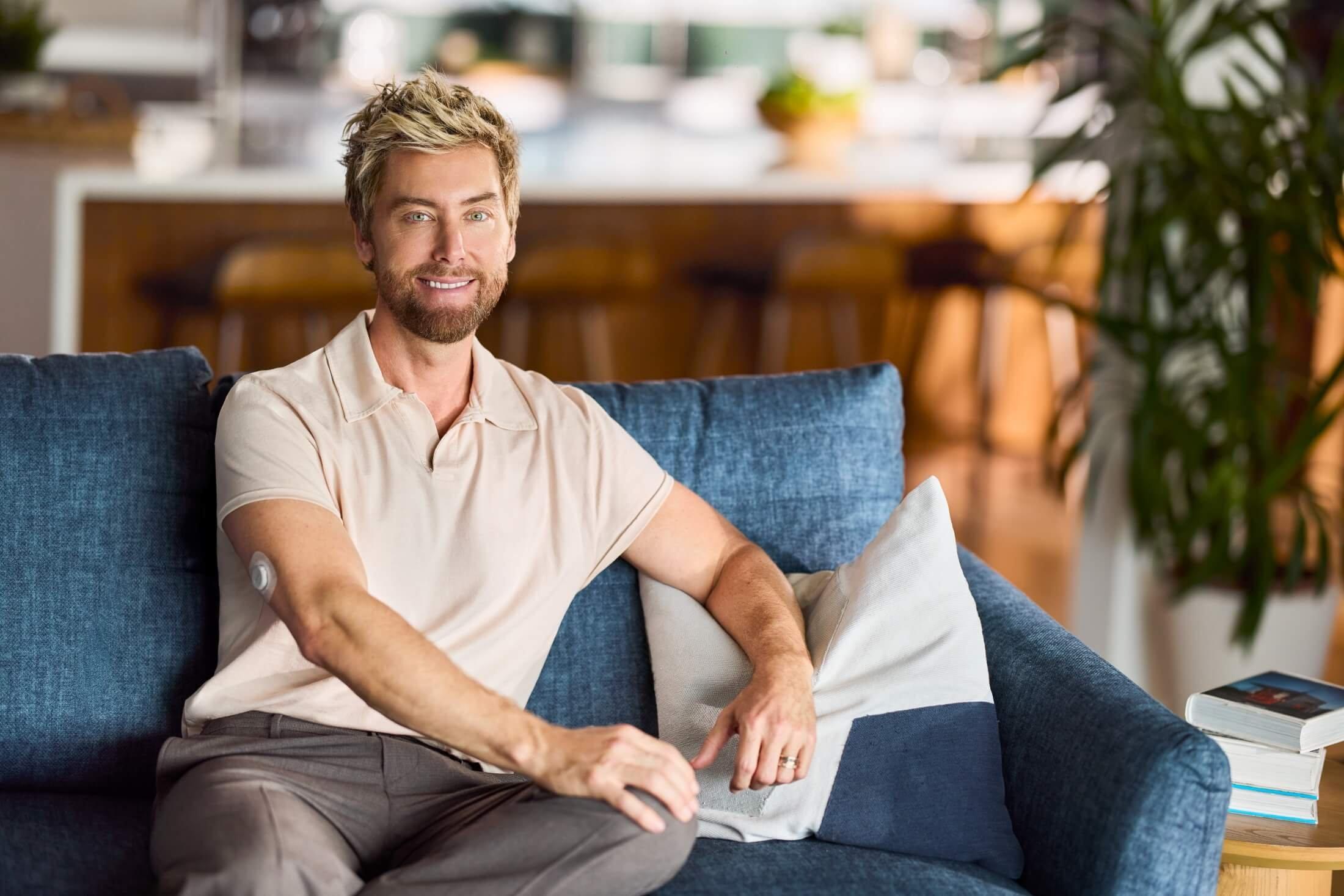 Lance Bass sitting on a couch