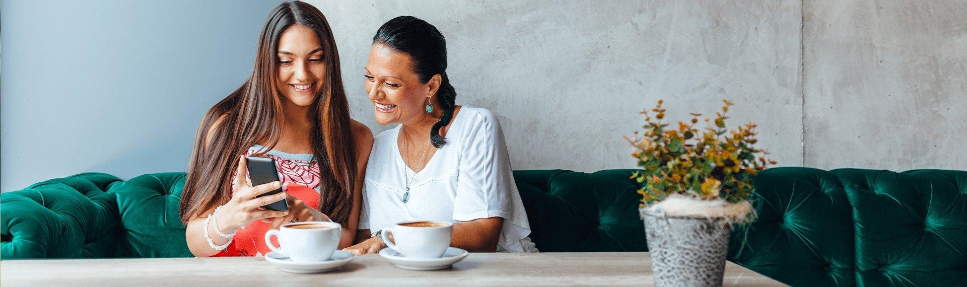 Two women drinking coffee together